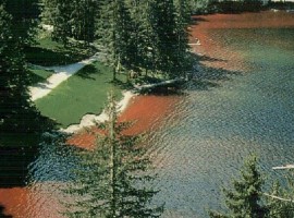 Red lake in the middle of mountains